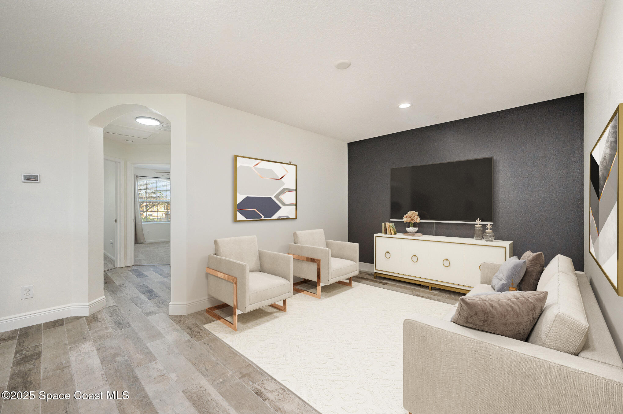 3226 Arden Circle Melbourne, FL 32934 - Photo 30 of 43 a living room with furniture and a flat screen tv