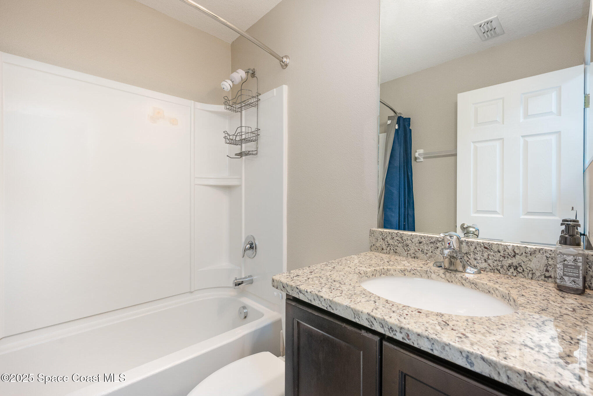 3226 Arden Circle Melbourne, FL 32934 - Photo 32 of 43 a bathroom with a granite countertop sink and a mirror