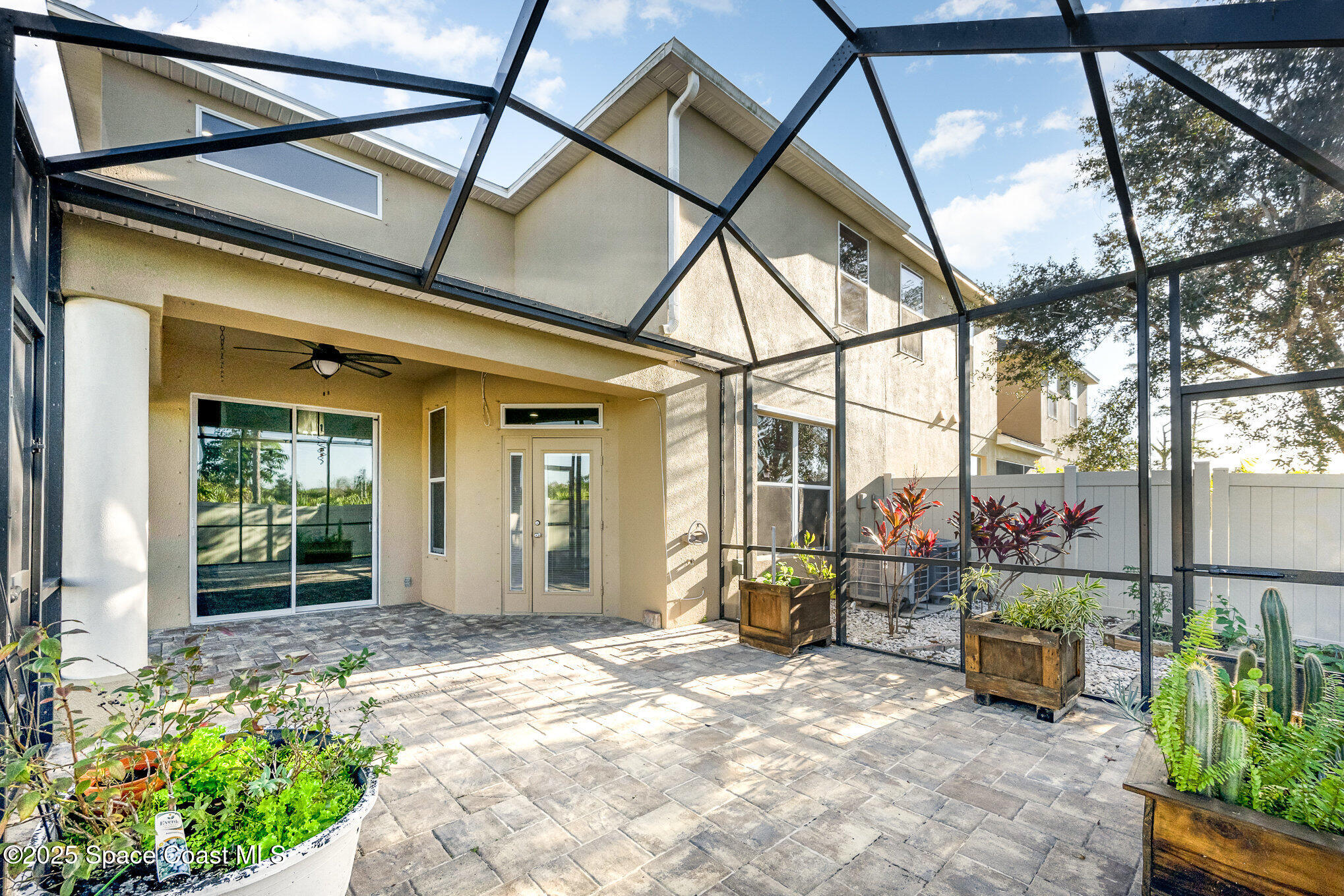 3226 Arden Circle Melbourne, FL 32934 - Photo 34 of 43 a view of a house with large windows and flower plants