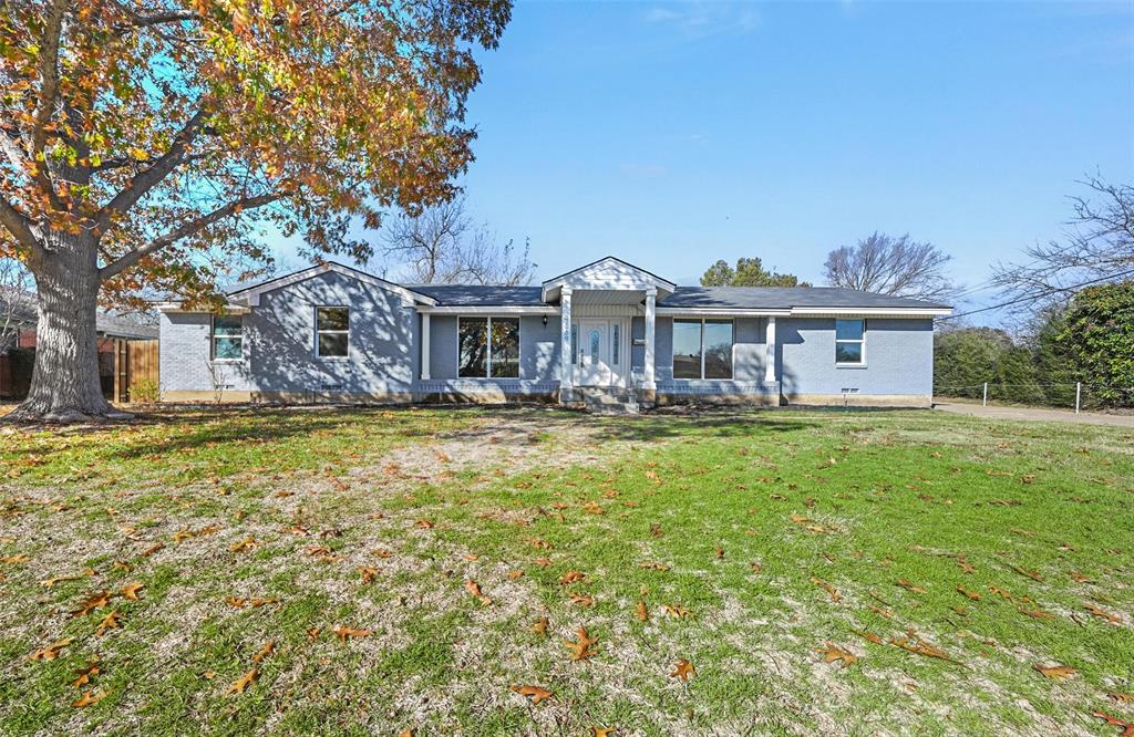 a front view of a house with a yard table and chairs
