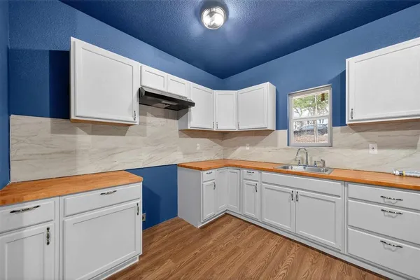a kitchen with a sink cabinets and window