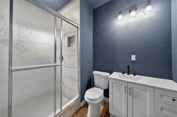 a white toilet sitting next to a bathroom sink