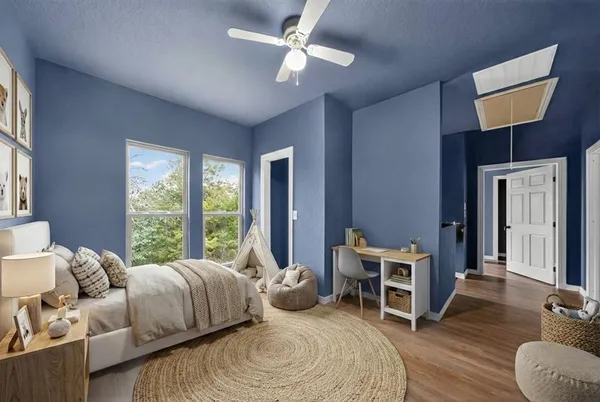 a bedroom with a bed a couch and a window