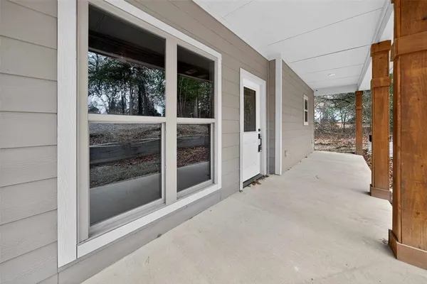 a view of a room with a glass door and a window