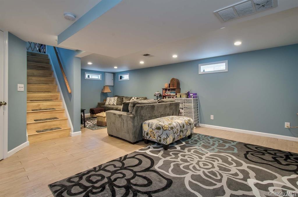 15 Janet Drive Plainview, NY 11803 - Photo 11 of 23 a living room with furniture and a wooden floor