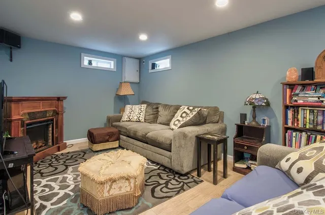 a living room with furniture a flat screen tv and a fireplace