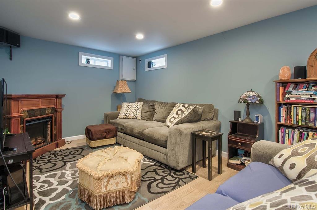 15 Janet Drive Plainview, NY 11803 - Photo 12 of 23 a living room with furniture a flat screen tv and a fireplace