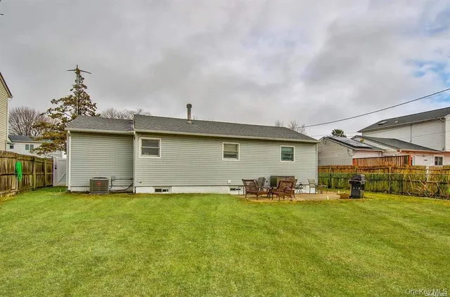 a backyard of a house with yard and outdoor seating