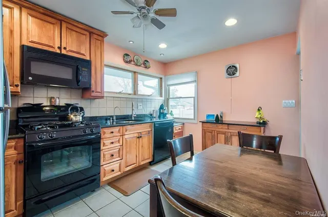 a kitchen with stainless steel appliances granite countertop wooden cabinets a stove top oven a sink and dishwasher