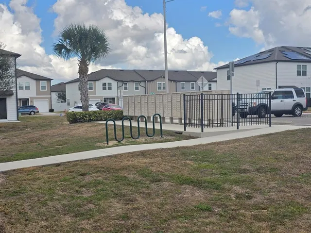 a view of a chair and table in backyard of the house