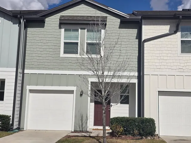 a front view of a house with a garage