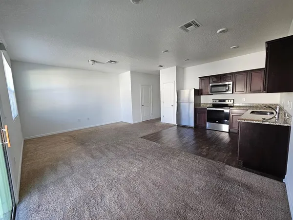 a kitchen with stainless steel appliances granite countertop a stove and a refrigerator