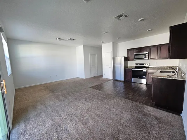 a kitchen with stainless steel appliances granite countertop a stove and a refrigerator