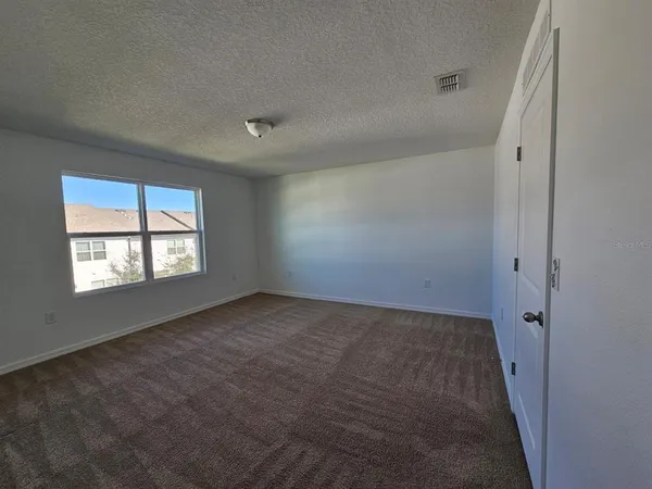 an empty room with a empty space and windows