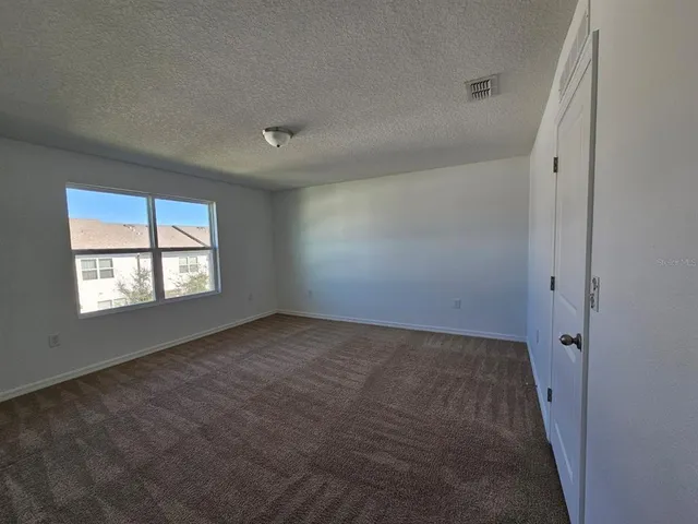 an empty room with a empty space and windows