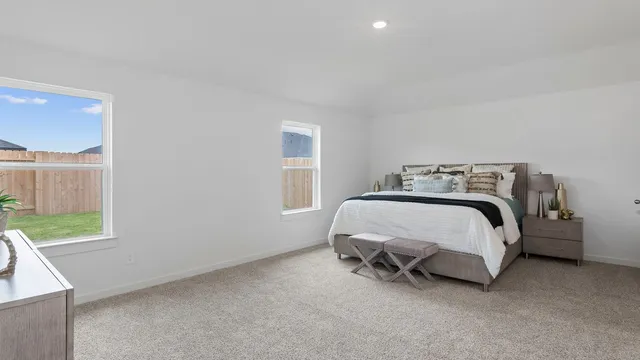 a bed sitting in a bedroom next to a window