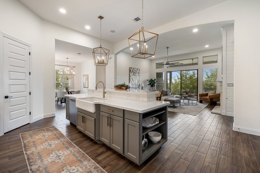 17641 Stratus Cove Dripping Springs, TX 78620 - Photo 40 of 40 Kitchen featuring ceiling fan, gray cabinets, wood tiled floors, a kitchen island with sink, and open floor plan