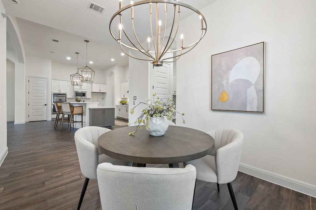 17641 Stratus Cove Dripping Springs, TX 78620 - Photo 14 of 40 Dining space with hanging lights, dark wood finished floors, a high ceiling, and arched walkways