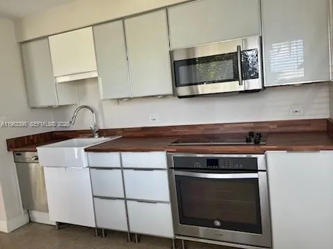 a stove top oven sitting inside of a kitchen