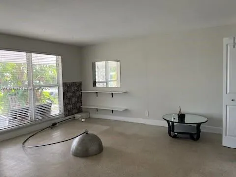 a room with gym equipment and a large window