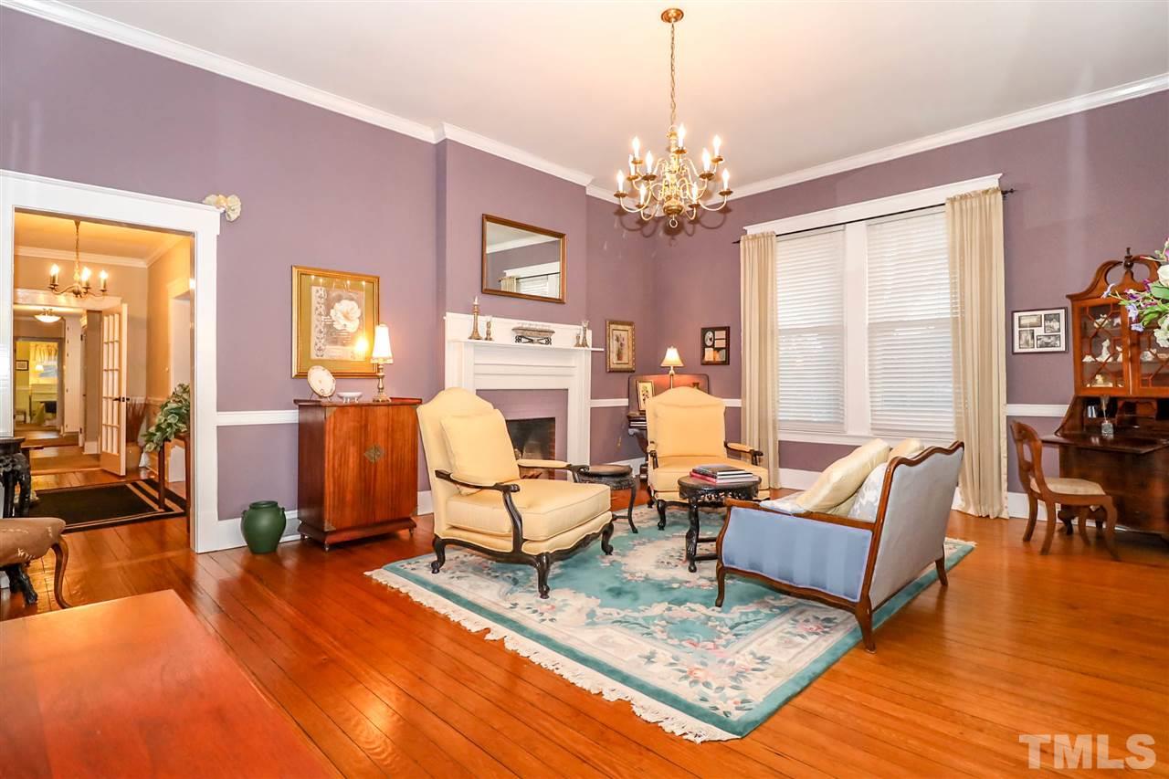 An elegant space with original hardwood flooring and 10ft ceilings. Fireplace is capped and only for decorative purposes in this room.