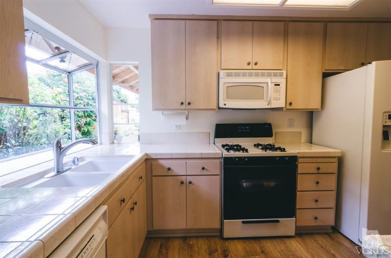 1757 Old Ranch Road Camarillo, CA 93012 - Photo 11 of 39 a kitchen with granite countertop a sink stove and refrigerator