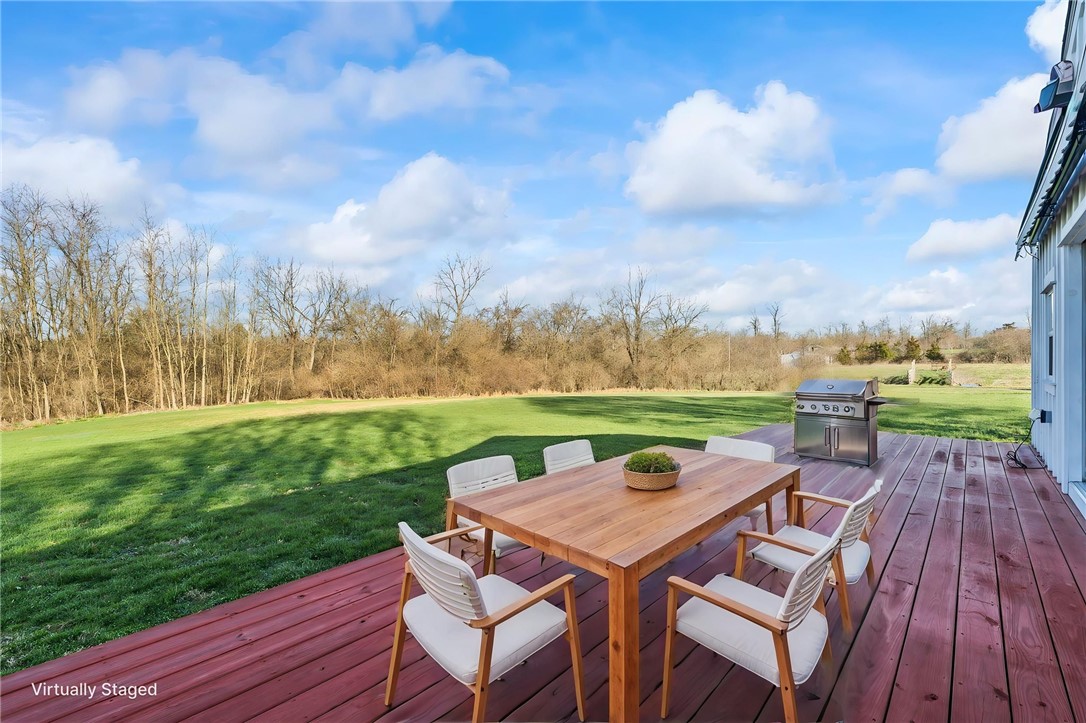10797 Gratis Jacksonburg Road Somerville, OH 45064 - Photo 20 of 27 Enjoy outdoor gatherings on this spacious deck, offering expansive views of lush greenery.