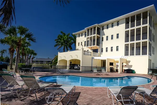a view of house with swimming pool outdoor seating
