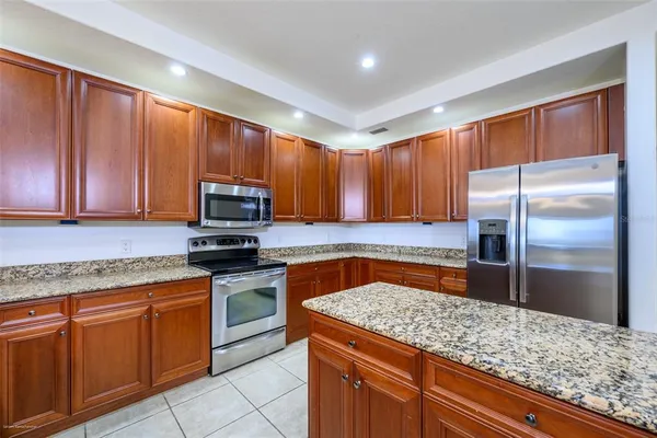a kitchen with a sink refrigerator and cabinets