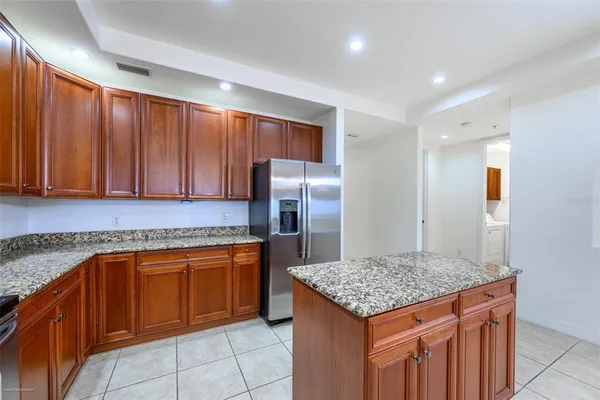a kitchen with stainless steel appliances granite countertop a sink stove and cabinets