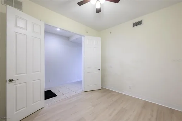 a view of a hallway with closet and a bathroom