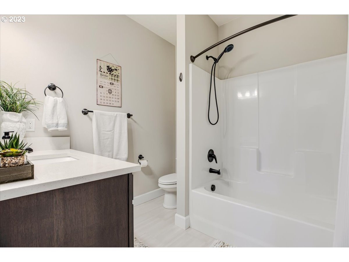 133 Northeast Regan Hill Loop Estacada, OR 97023 - Photo 20 of 29 a bathroom with a granite countertop sink a toilet and shower