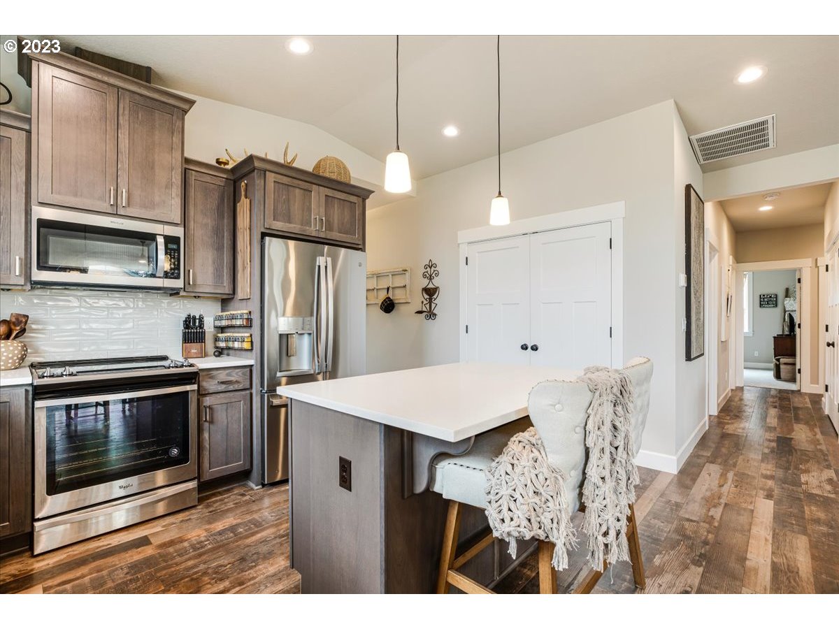 133 Northeast Regan Hill Loop Estacada, OR 97023 - Photo 4 of 29 a kitchen with stainless steel appliances a stove a refrigerator sink and microwave