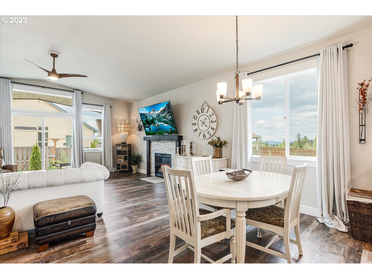 133 Northeast Regan Hill Loop Estacada, OR 97023 - Photo 8 of 29 a dining room with furniture a chandelier and wooden floor