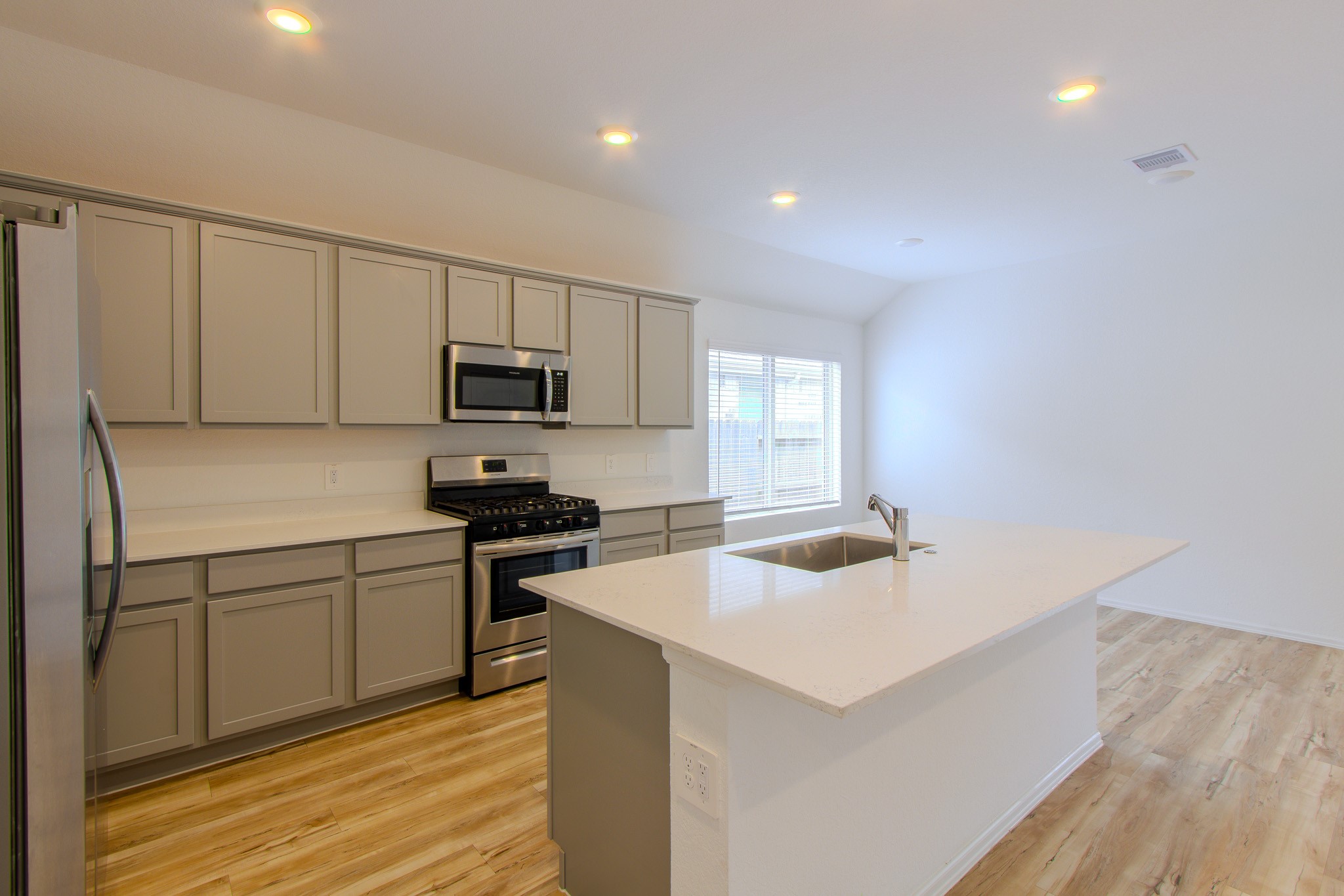 3113 Catalonion Court Conroe, TX 77301 - Photo 14 of 45 a kitchen with cabinets and wooden floor