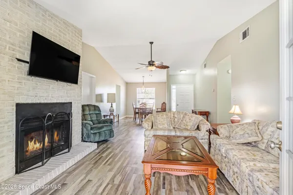 a living room with furniture fireplace and flat screen tv