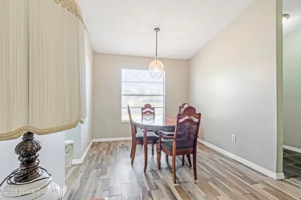 a dining room with furniture and window