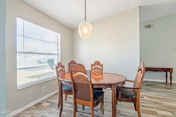 a view of a dining room with furniture window and wooden floor