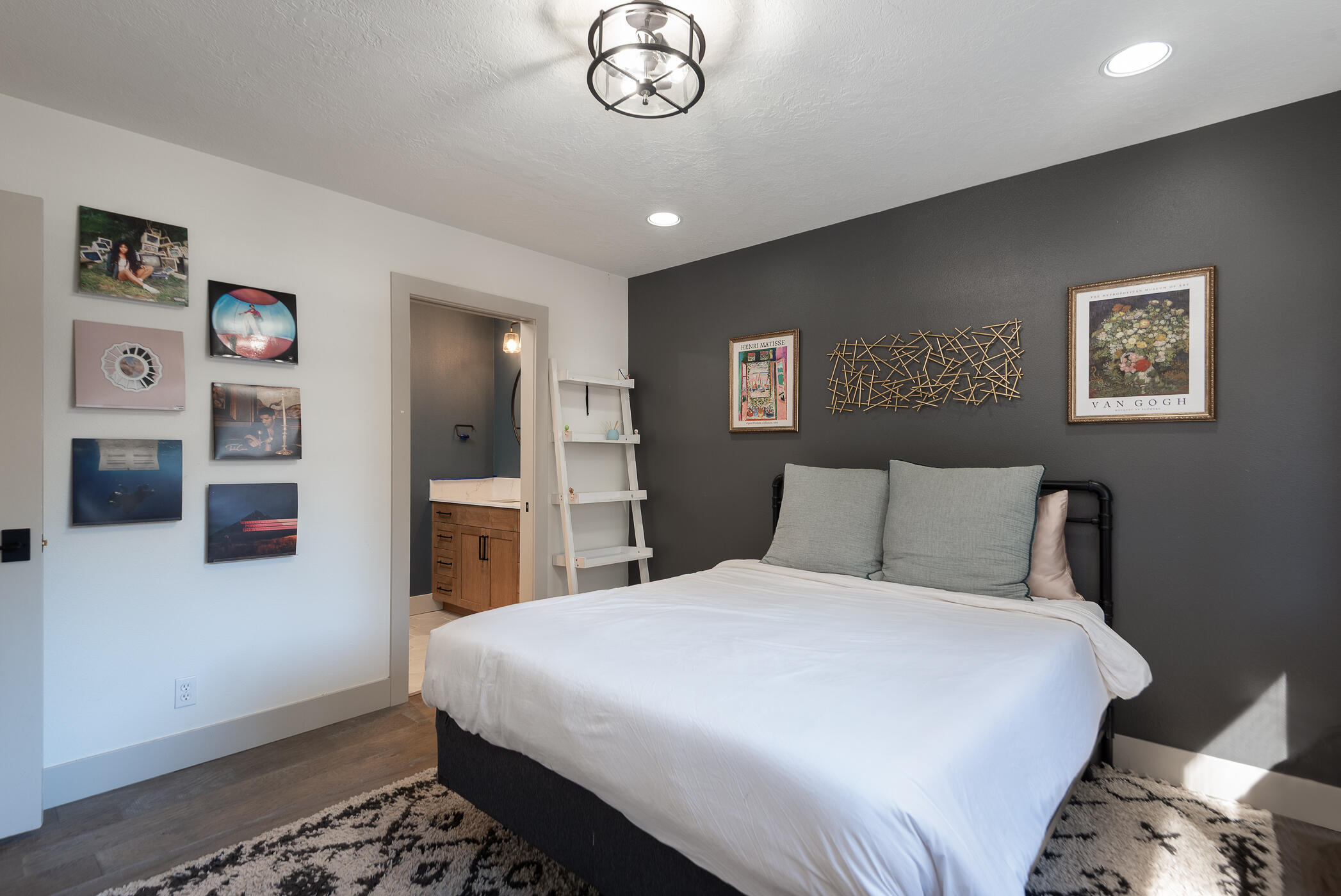 60012 West Ridgeview Drive Bend, OR 97702 - Photo 25 of 55 a bedroom with a large bed and a chandelier
