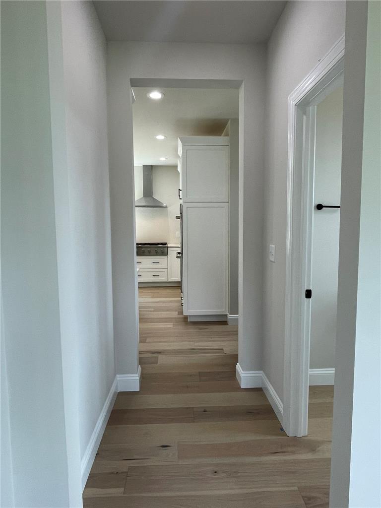 5043 Chapmans Road Orefield, PA 18069 - Photo 7 of 30 Natural wood flooring extends into a modern kitchen, creating a seamless flow throughout this inviting space.