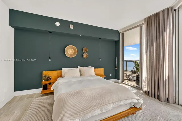 a bedroom with a bed and a lamp next to a window