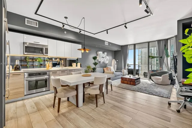 a view of a dining room with furniture window and wooden floor