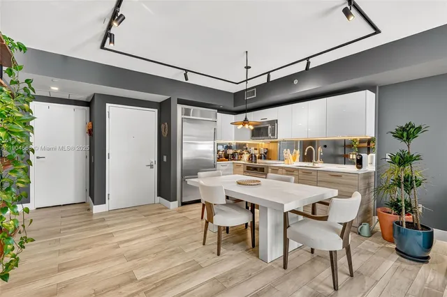 a view of a dining room with furniture and wooden floor