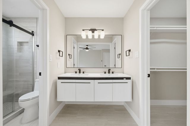 a bathroom with a toilet a sink and a mirror