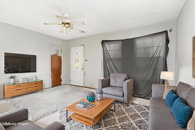 a living room with furniture and a flat screen tv
