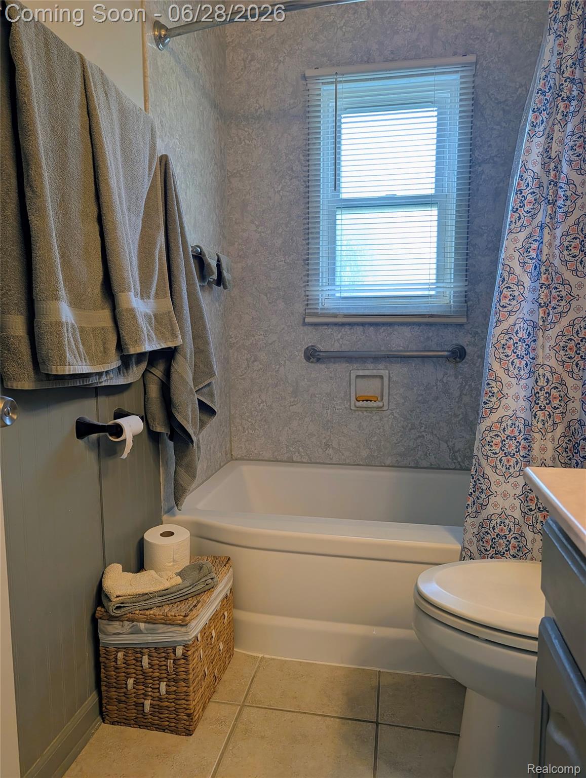 4456 East Coldwater Road Flint, MI 48506 - Photo 13 of 35 Bathroom featuring a white bathtub, tiled shower surround, and a window with blinds