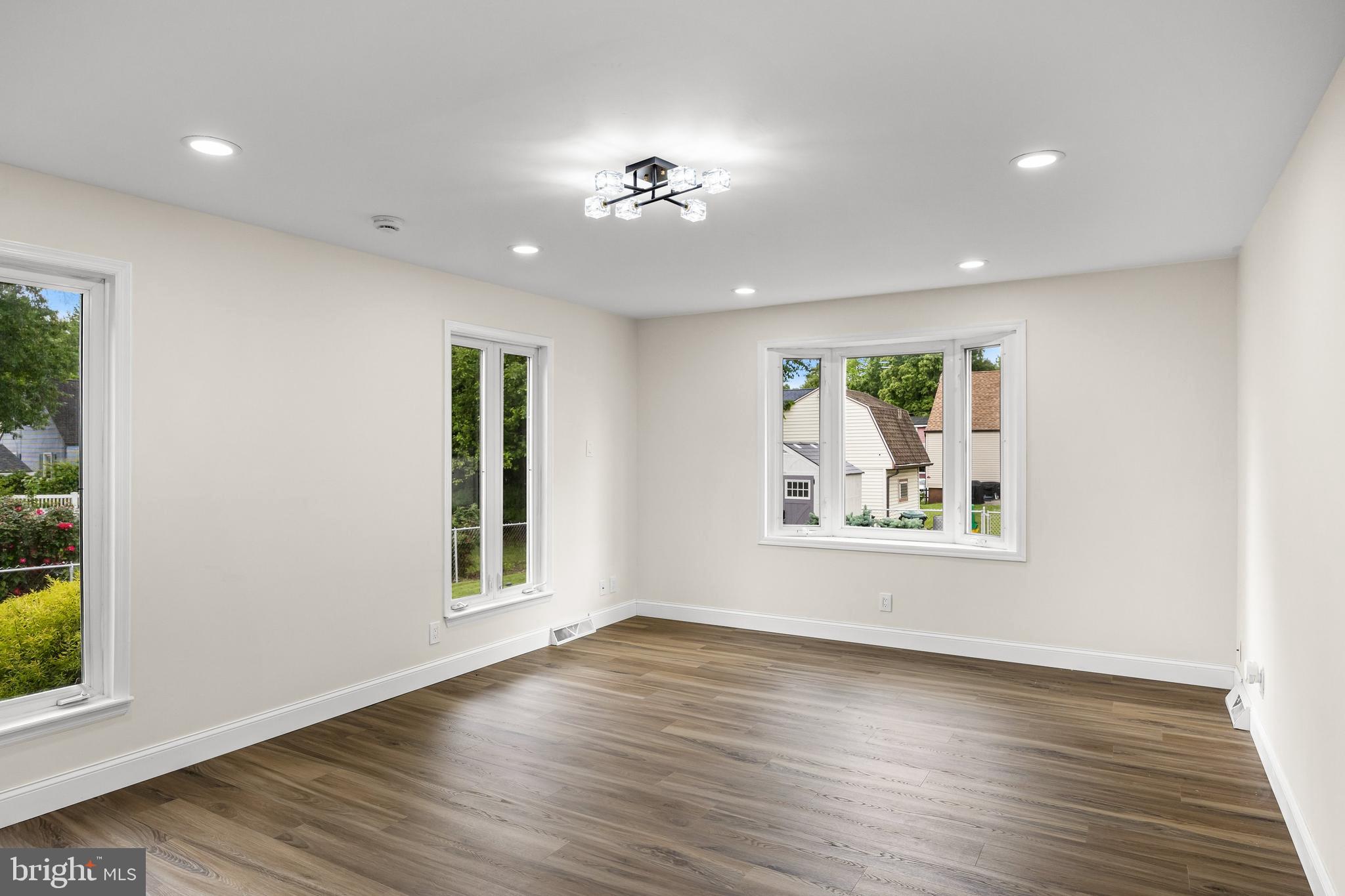 937 Clements Bridge Road Barrington, NJ 08007 - Photo 22 of 34 a view of an empty room with wooden floor and a window