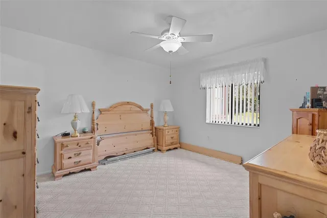 a view of bedroom with workspace and windows