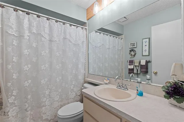 an aerial view of a house with a yard basket ball court and outdoor seating