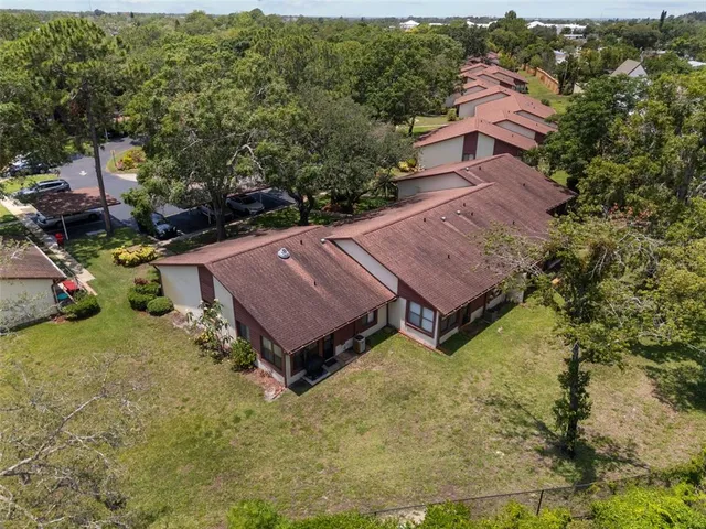 a view of a patio with table and chairs with wooden fence and plants